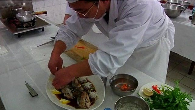 A North Korean chef preparing his signature dish