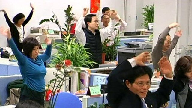 Taiwanese workers exercise at their desk