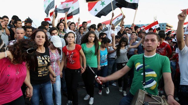 Pro-regime Syrians at a rally in Damascus