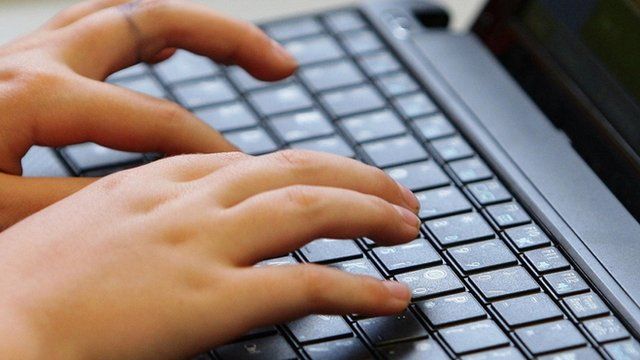 Typing on a laptop
