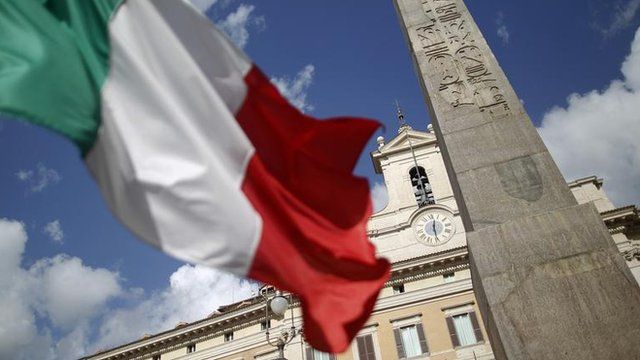An Italian flag in front of the Montecitorio palace in Rome