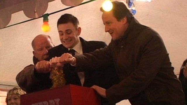 David Cameron prepares to push a lever to switch on Witney's Christmas lights