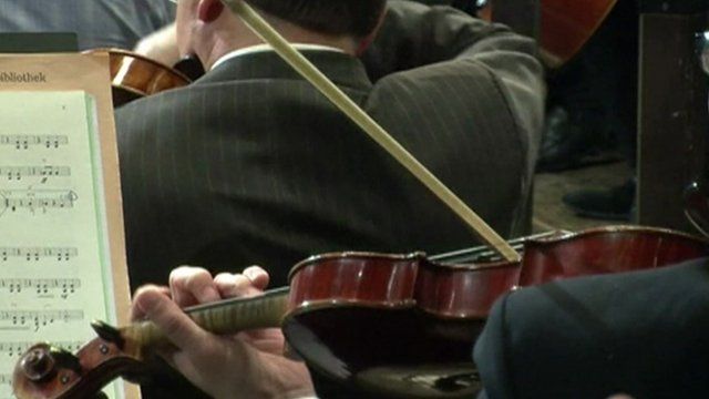 Men playing violins