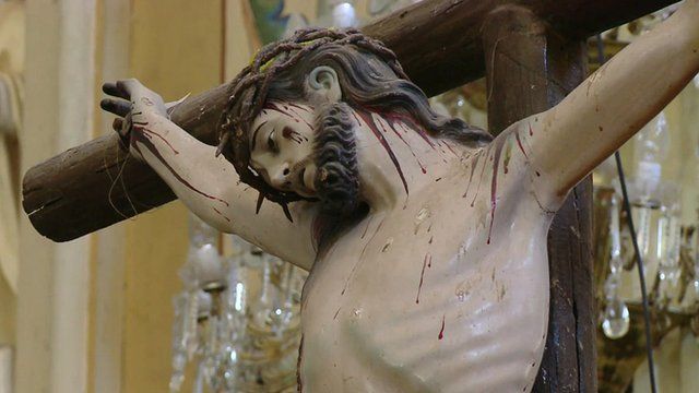 A statue of Jesus Christ on the cross in a Mexican church
