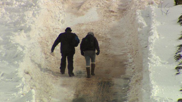 Walking up snowy hill