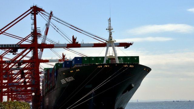 A cargo boat being loaded at the port of Tokyo