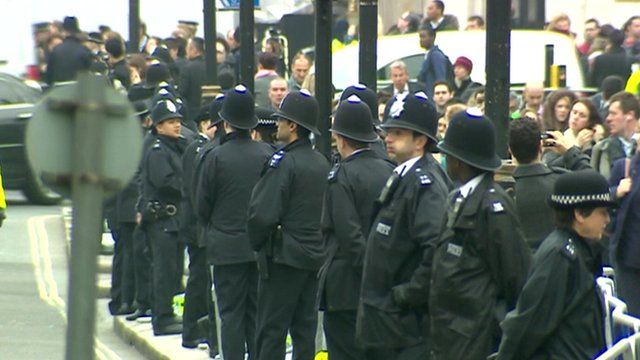 Police line the funeral procession route