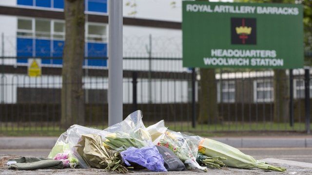 Floral tributes are seen outside the Royal Military Barracks