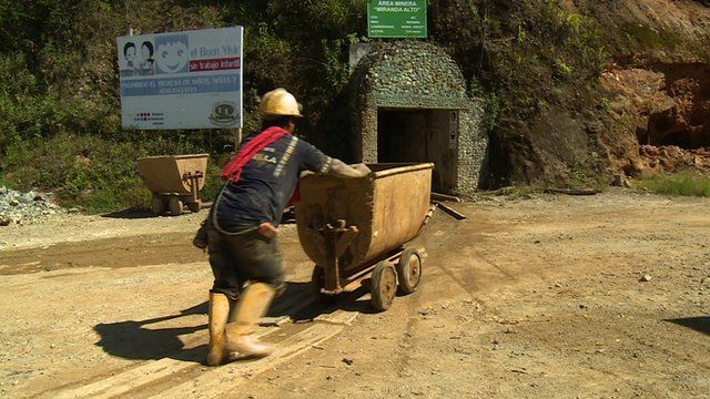 Man pushing cart outside gold mine in Ecuador