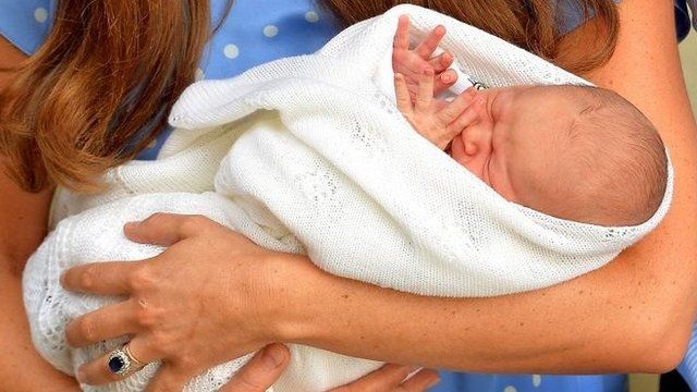 Prince George of Cambridge cradled by the Duchess of Cambridge