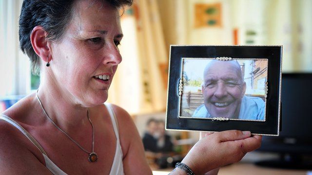 Tanya with a photo of her murdered husband Gary