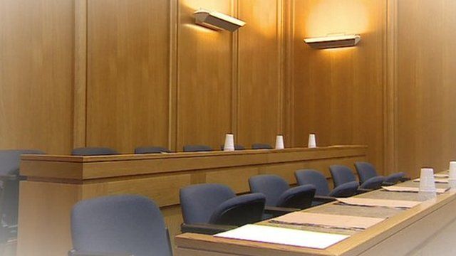 An empty jury bench inside a courtroom