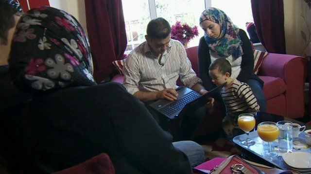 A family looking at a computer