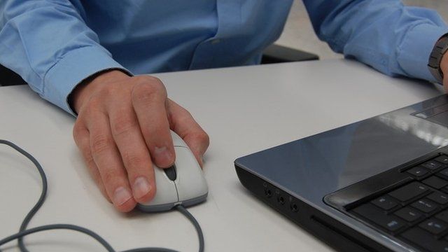 Man using a laptop mouse