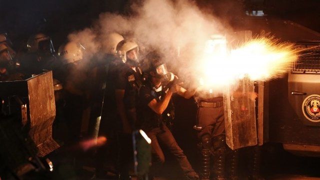 Riot police fire tear gas at protesters during clashes in central Hatay, September 11, 2013
