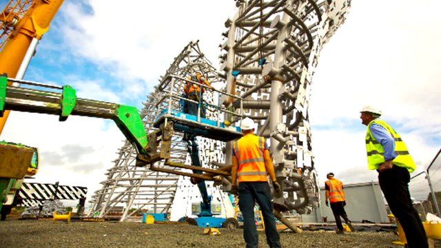 Workers putting The Kelpies in place