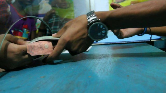 Money handed to bank teller