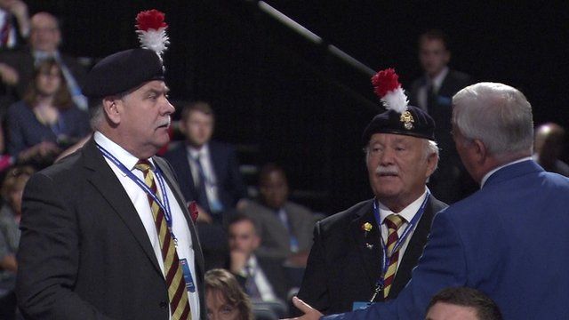 Retired army colonel and friend being addressed by usher