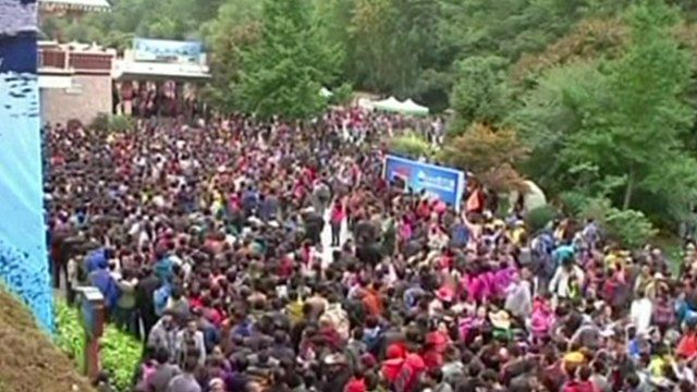 People wait outside the entrance to the Jiuzhaigou scenic spot
