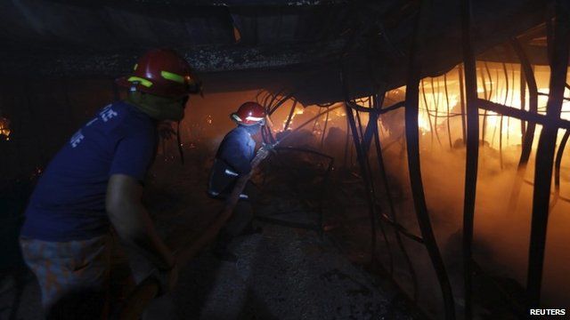 Firefighters try to control a fire inside a garment factory in the Bangladeshi town of Gazipur