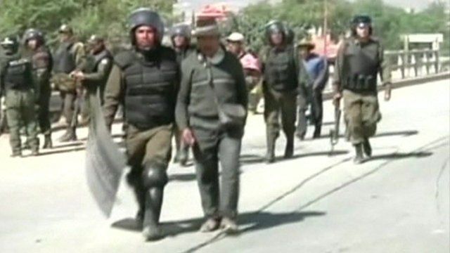 A man who took part in protests is taken away by riot police