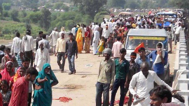 People gathered on the bridge following a stampede outside the Ratangarh Temple in Datia district, India"s Madhya Pradesh state
