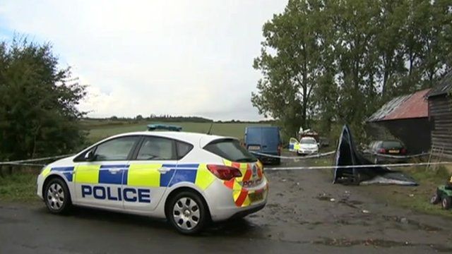 Police car at Begwary barn, scene of stabbings