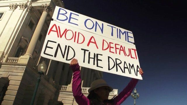 Woman holding up placard against the government shutdown