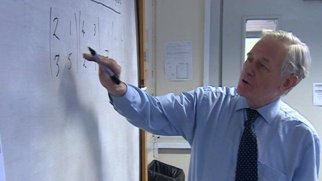 Maths teacher David Shrubbs writing on a board