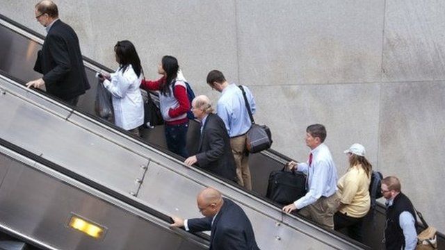 People exit a Metro subway station, by escalator, along Pennsylvania Ave., NW, in Washington, Thursday, Oct. 17, 2013