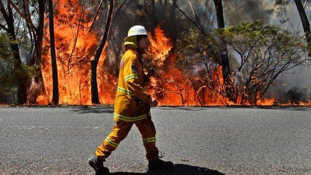 A firefighter monitors a back burn