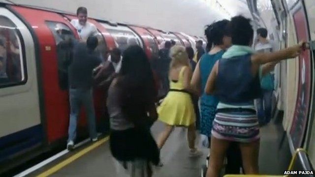Passengers at Holland Park station during the evacuation