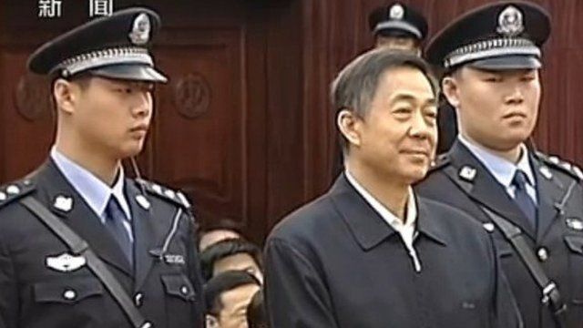 Bo Xilai stands between two guards in court