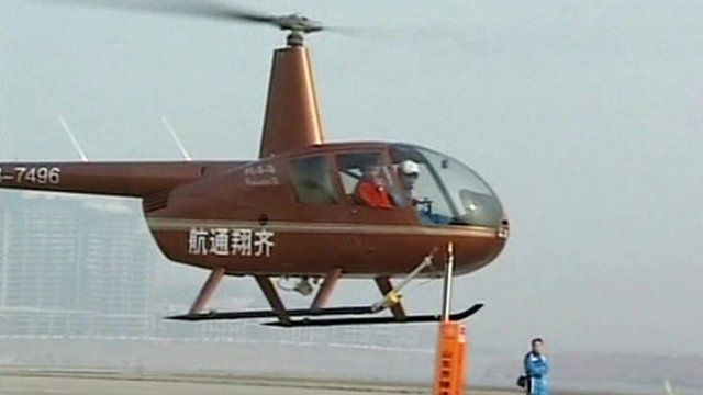 Helicopter pilot positioned to remove top off a beer bottle