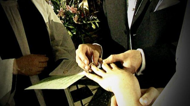 Man puts ring on woman's finger