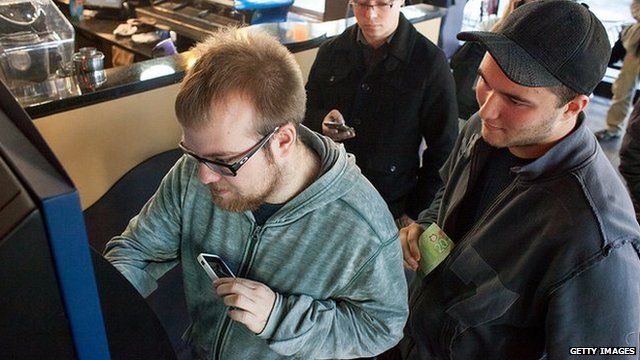 People queue up to use the world's first Bitcoin ATM