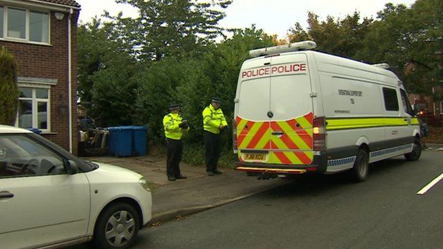Police outside the property in October