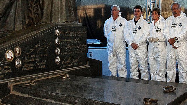 A team of forensic scientists stand by the tomb of Brazilian former president Joao Goulart
