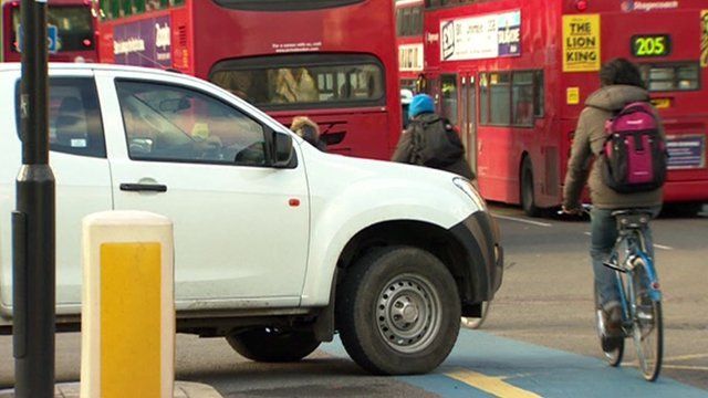 People cycling in traffic