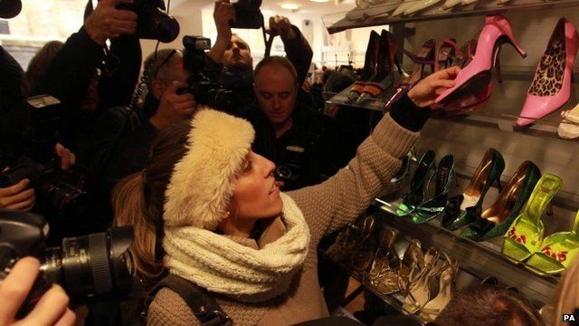 Woman picks up shoes donated by Victoria Beckham
