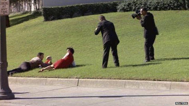 Bill and Gayle Newman covering their children after shots were fired at President Kennedy