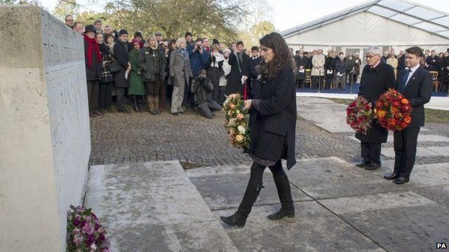 Tatiana Schlossberg lays a wreath at the memorial
