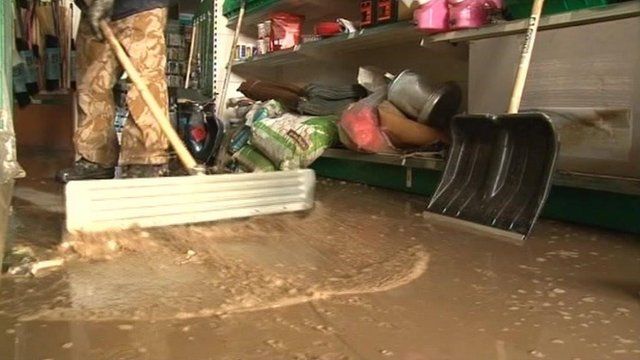 Floodwater is swept from a room