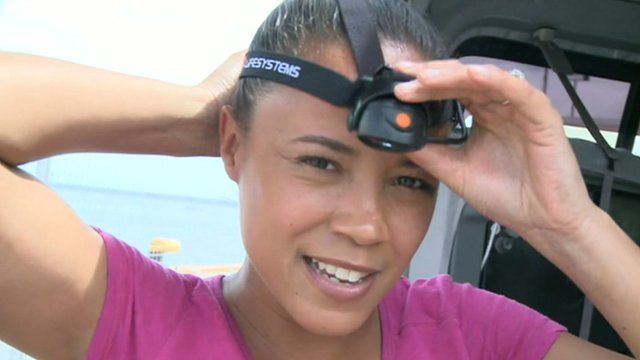 Leah wears a headtorch.