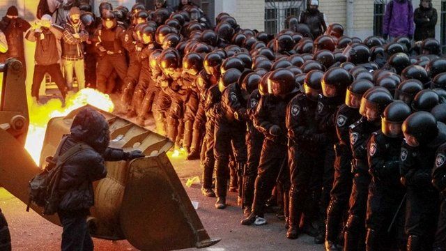 Protesters try to break through police lines near the presidential administration building during a rally held by supporters of EU integration in Kiev
