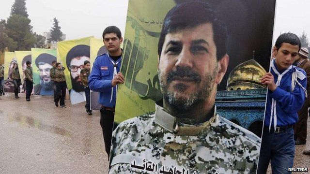 Hezbollah youth hold poster of killed commander Hassan Lakkis, Baalbek (4 Dec)