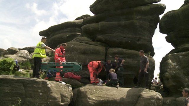 Rescue team attend to the fallen climber