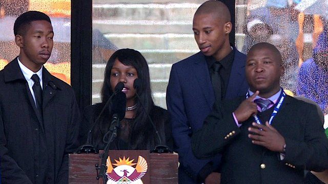 The sign language interpreter (far right) signs tributes by Nelson Mandela's grandchildren