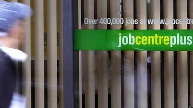 Man in front of Job Centre window