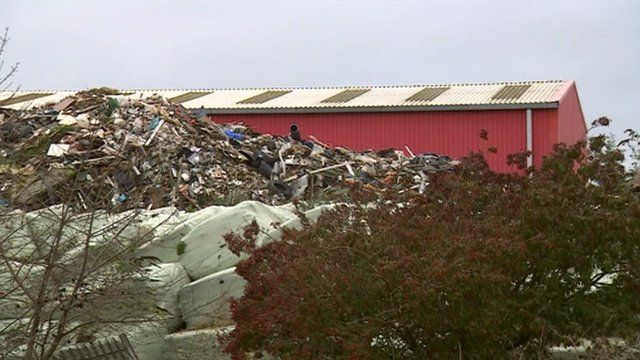 Waste pile next to warehouse